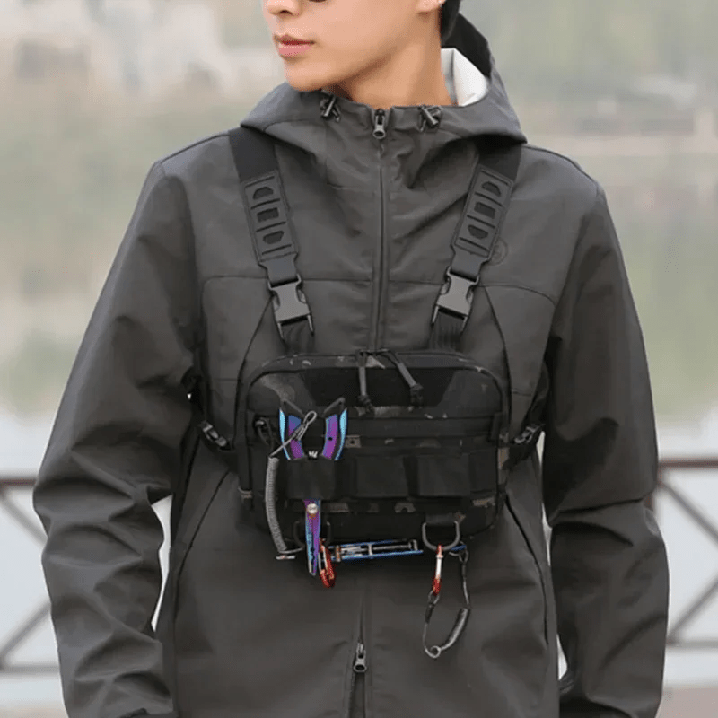 Person wearing Rovix tactical chest bag with fishing tools attached, showcasing hands-free gear access and outdoor utility.