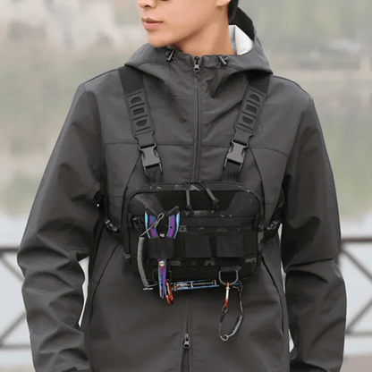 Person wearing Rovix tactical chest bag with fishing tools attached, showcasing hands-free gear access and outdoor utility.