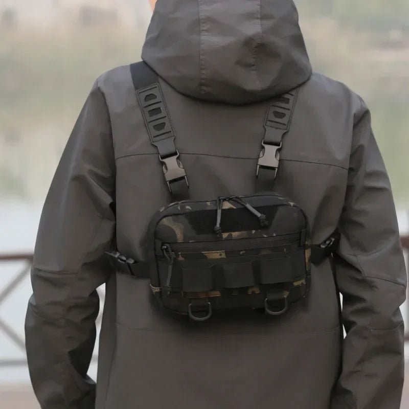 Man wearing Rovix tactical chest bag on his back while fishing, with flashlight and keys clipped to the bag for quick access.